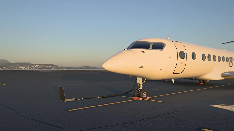 An artist’s impression of LUEUR nose first on the ramp at Nice, its nose gear chocked, in the last golden light, the coast behind.