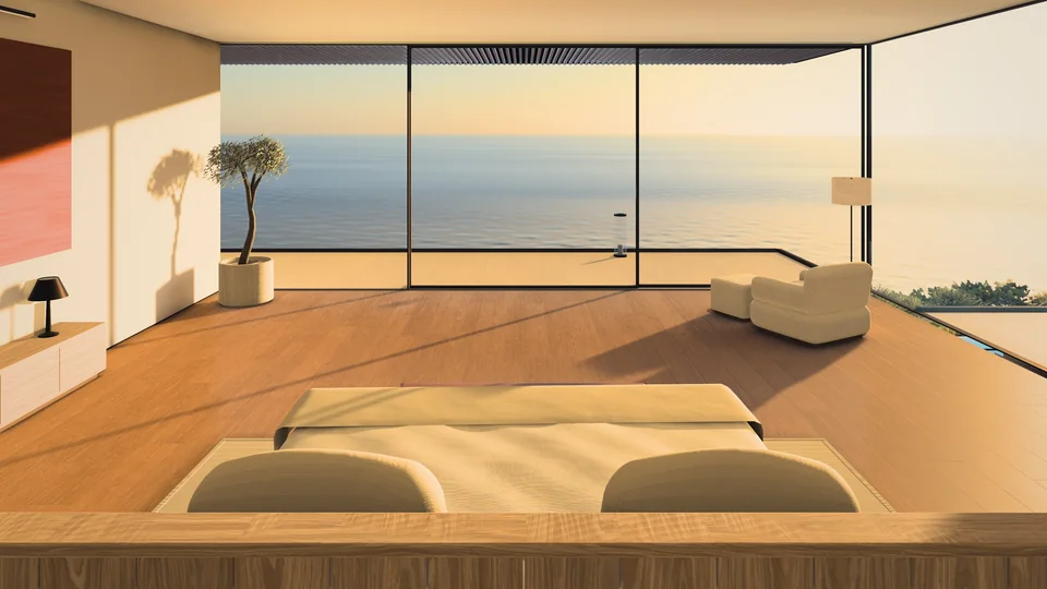 A suite in MIRALL in the evening light: the bed before a glass wall and the calm sea.
